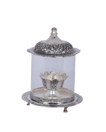 Silver decorative item with a clear glass cover on a white background