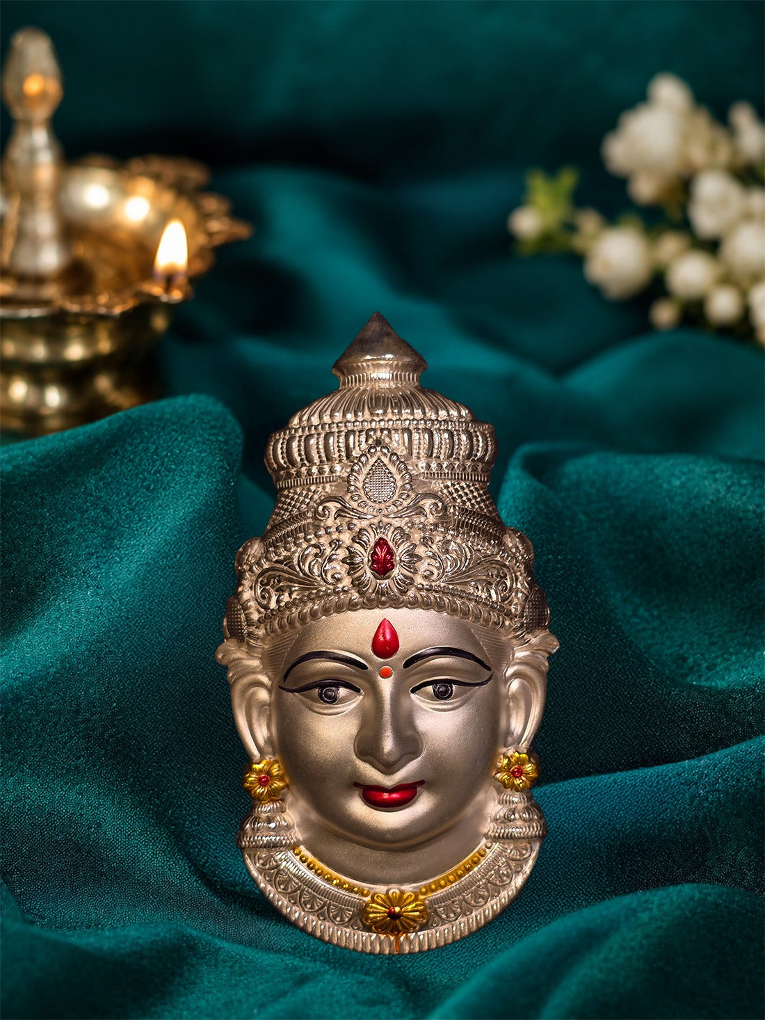 Silver deity face ornament, detailed crown and red forehead mark with small gold earrings