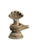Silver-toned Shiva lingam ornament, cobra/naag design, close-up on circular base