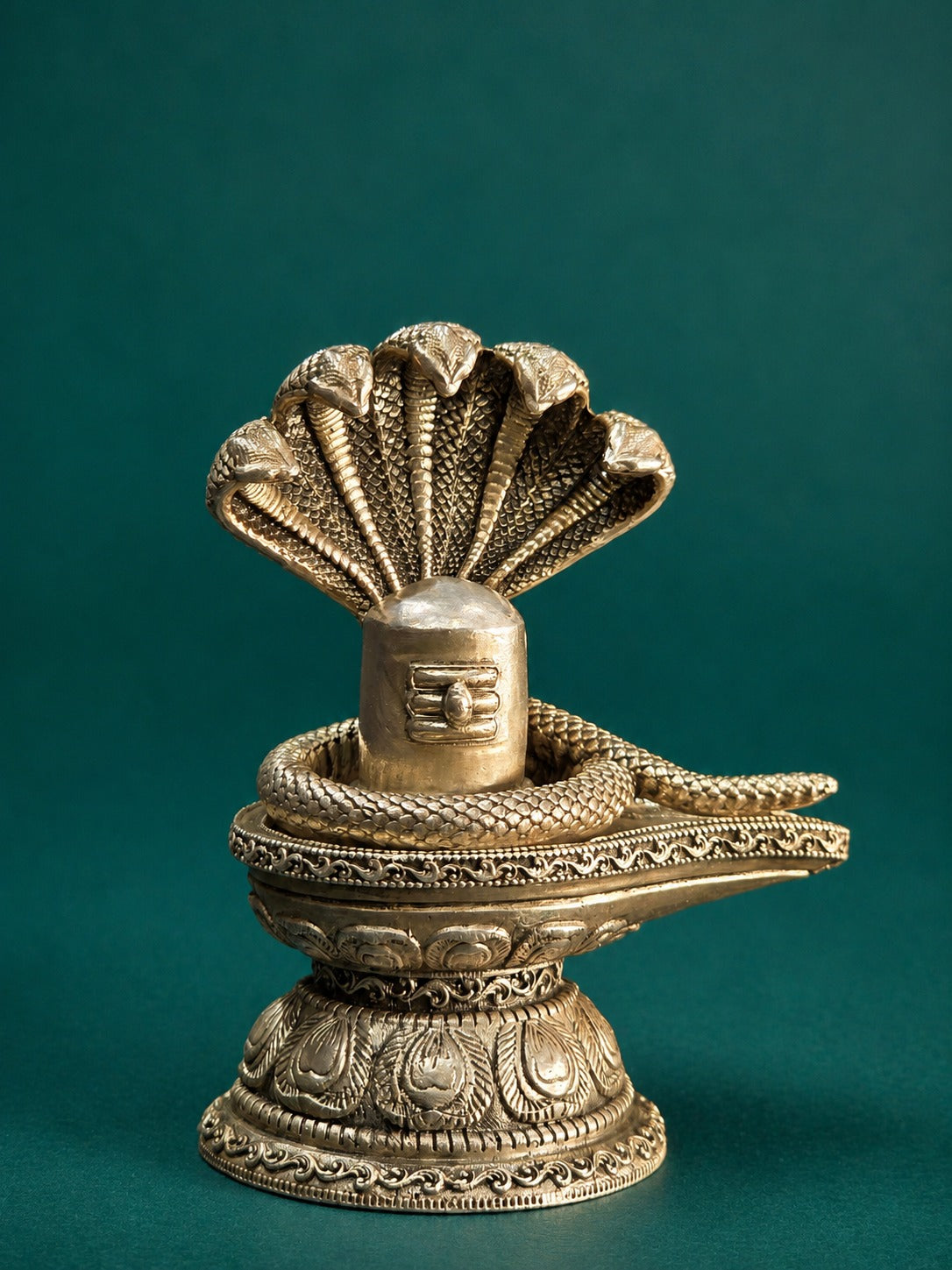 Silver-toned Shiva lingam ornament with Naag cobra coils, ornate textured platform