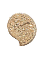 Embossed gold-tone kumkum box with leaf and swirl engravings, scalloped rim