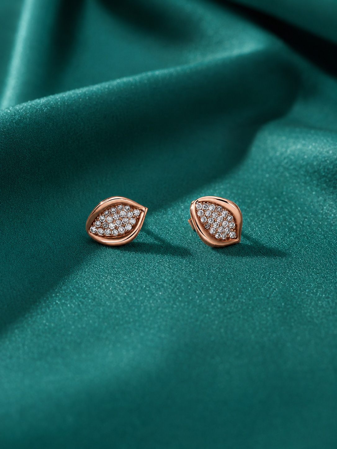 Designer silver stud earrings for women with pavé crystals and a modern rose-gold border.