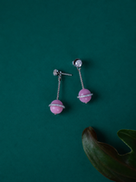 A pair of silver drop earrings with pink stone beads and clear rhinestone accents.
