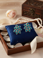 A pair of silver floral stud earrings with turquoise-blue stones.