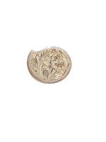 Embossed gold-tone round kumkum box for pooja, raised floral and leaf pattern