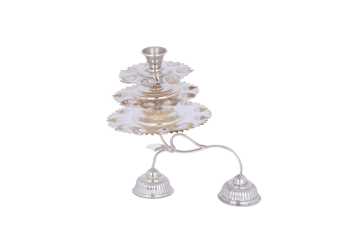 Silver candle holder with three small bells on a white background