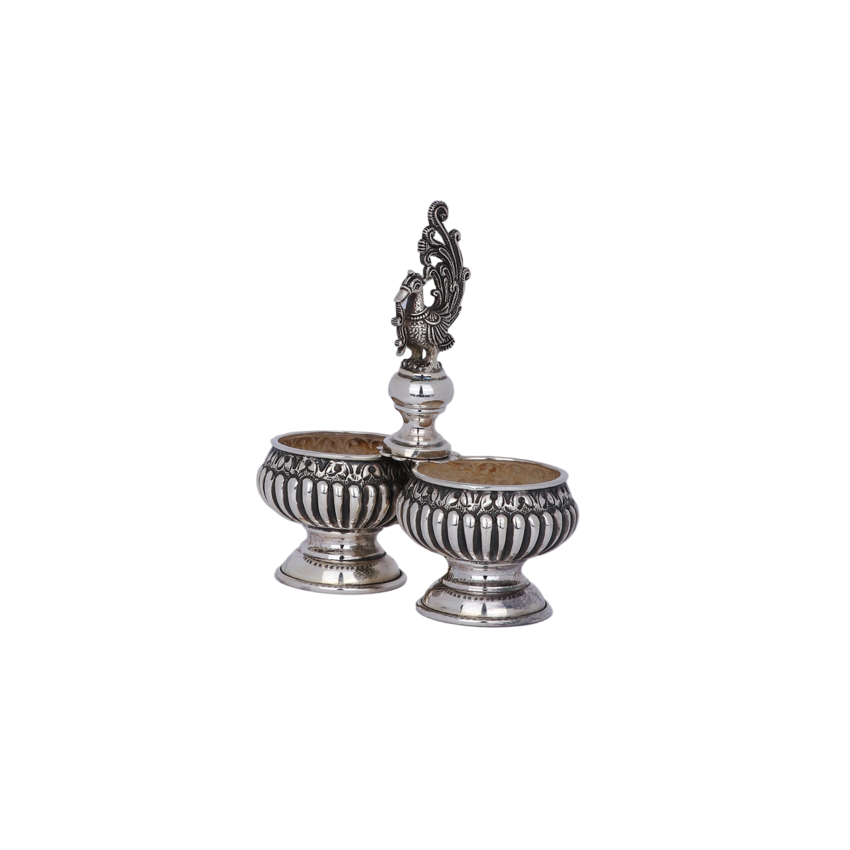 Pair of silver salt shakers with decorative top on a light gray background