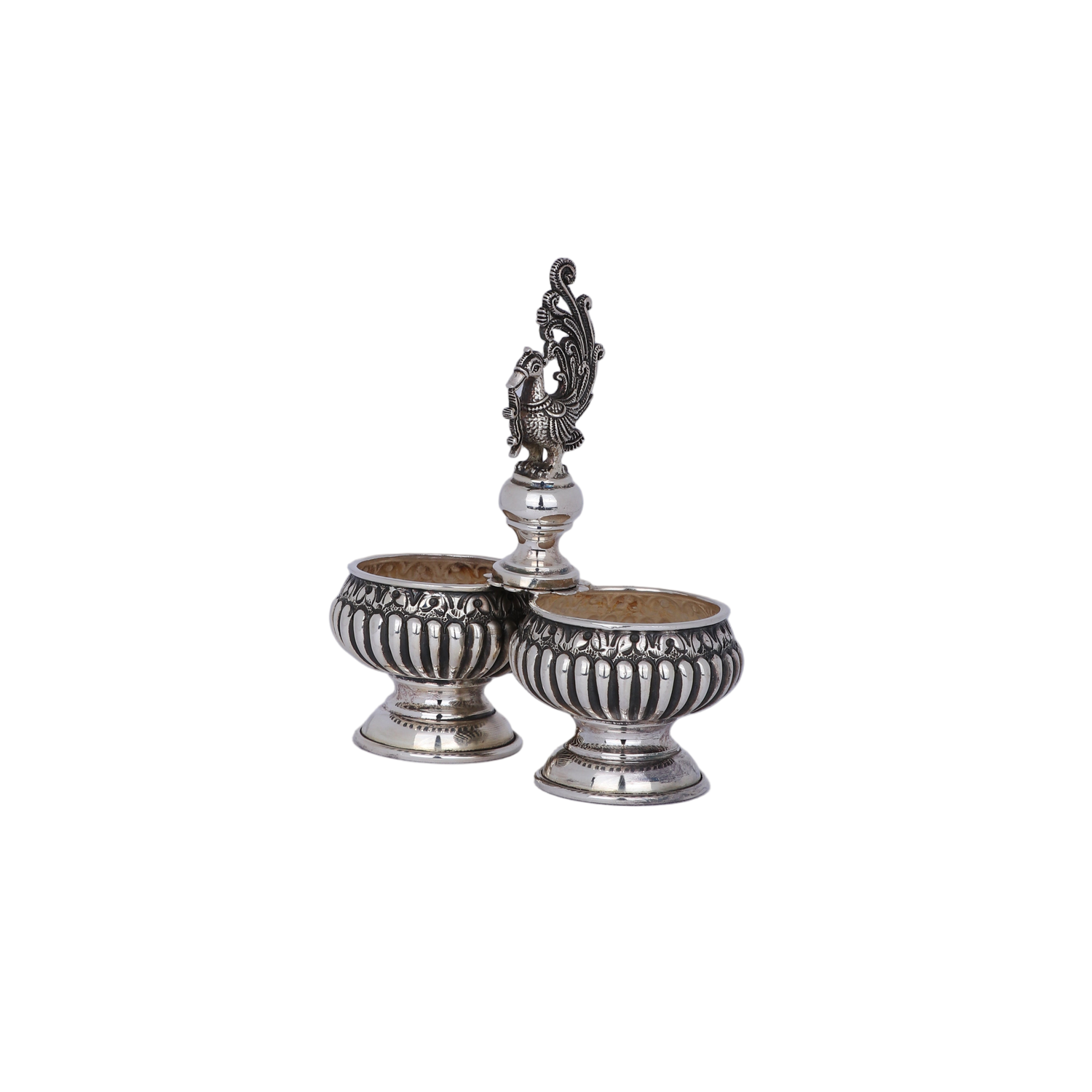 Pair of silver salt shakers with decorative top on a light gray background