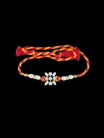 Sterling silver floral rakhi with pearl beads on red-yellow braided thread