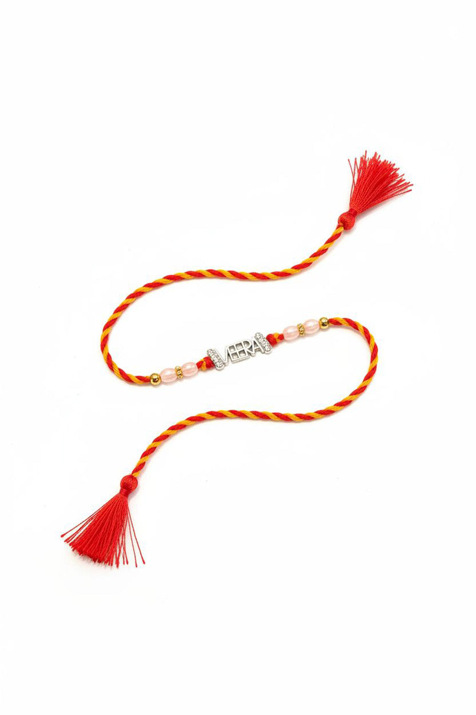 Laid rakhi with red braided cord, VEERA sterling charm, pearl beads, and tassels