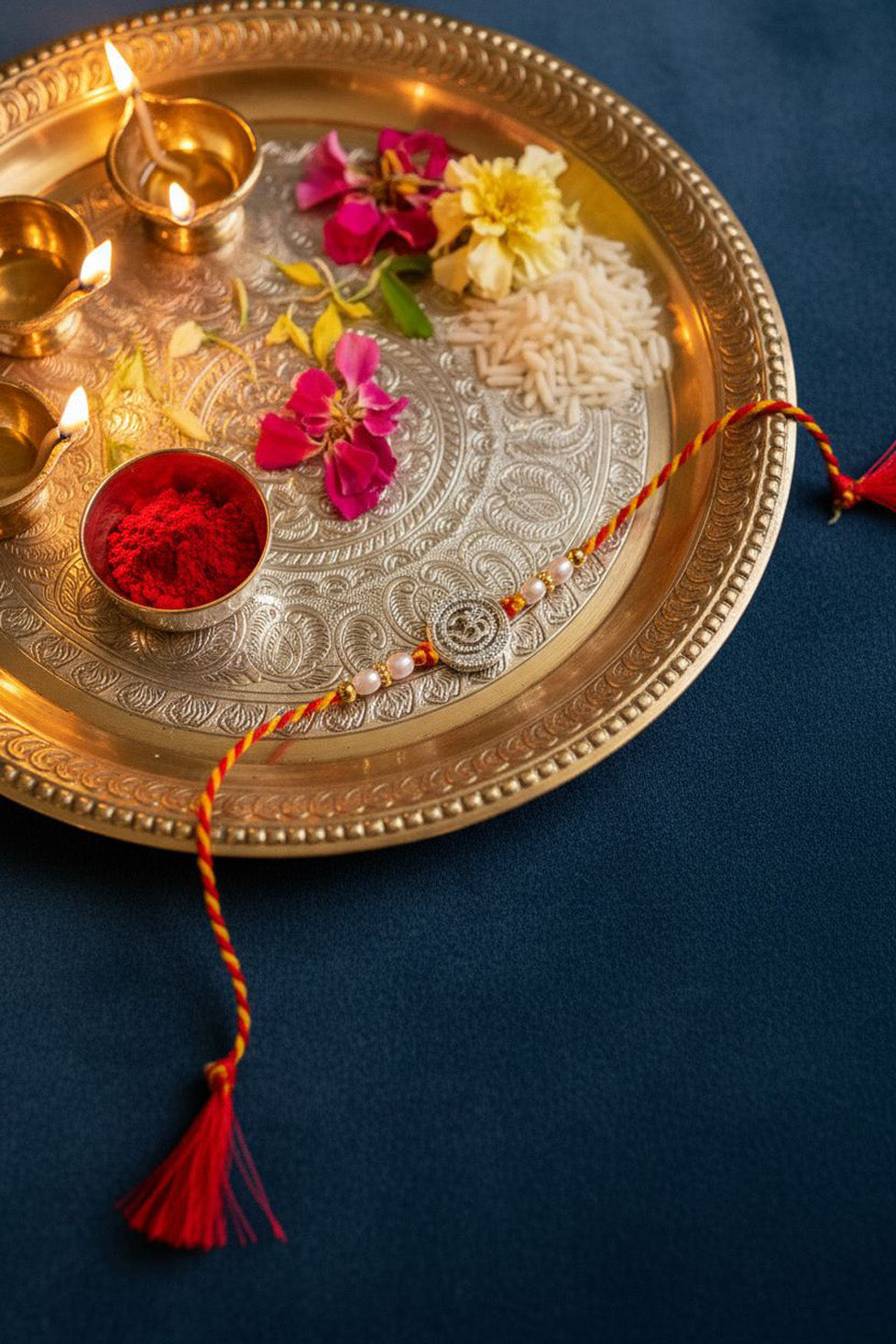 Sterling silver Om rakhi with pearl beads and red tassel