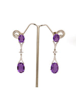 Buy women’s silver drop earrings with oval purple stones and sparkling crystal detailing online.