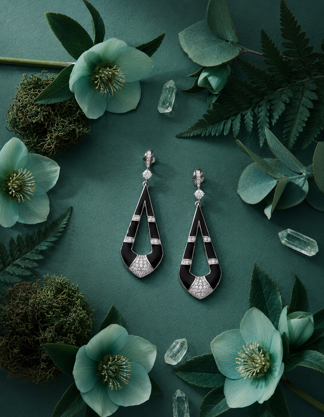 Statement silver earrings with an open teardrop design, black enamel sections and sparkling crystals.