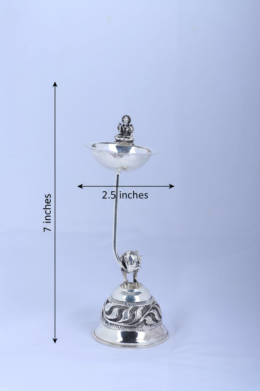 Silver-tone pooja diya lamp, 7 inches tall, 2.5 inches wide; bowl and bird figurine