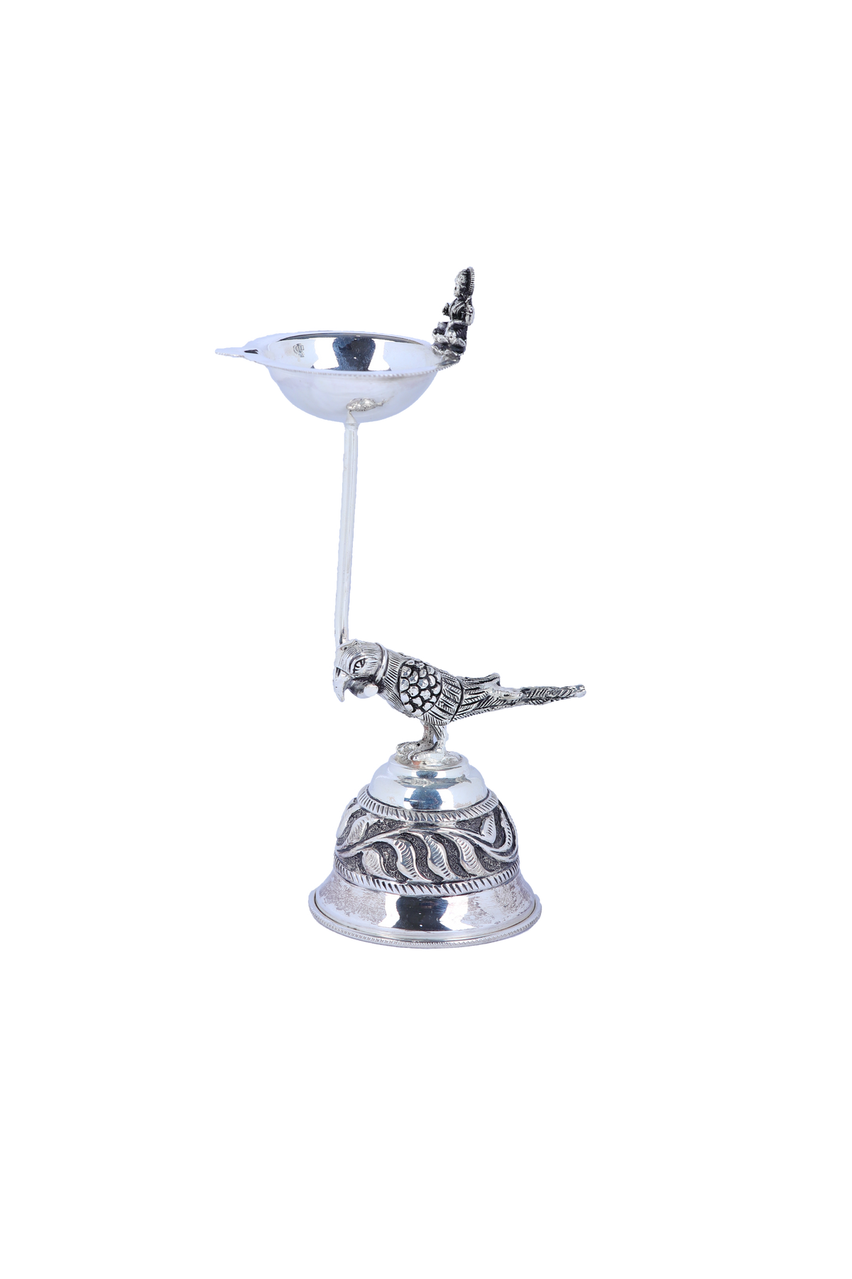 Silver-tone pooja diya lamp with pedestal, engraved base, and bird & deity figurines