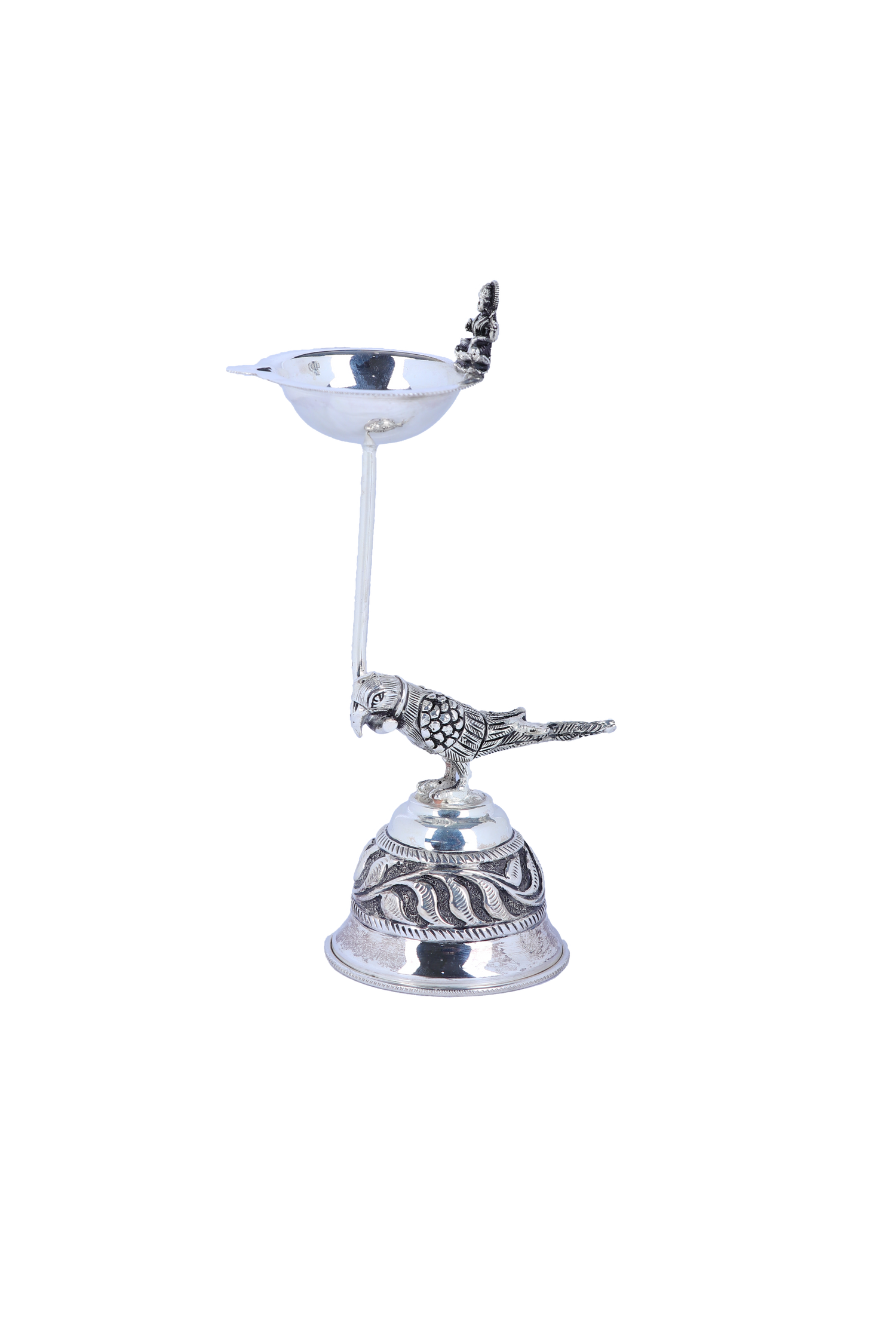 Silver-tone pooja diya lamp with pedestal, engraved base, and bird & deity figurines