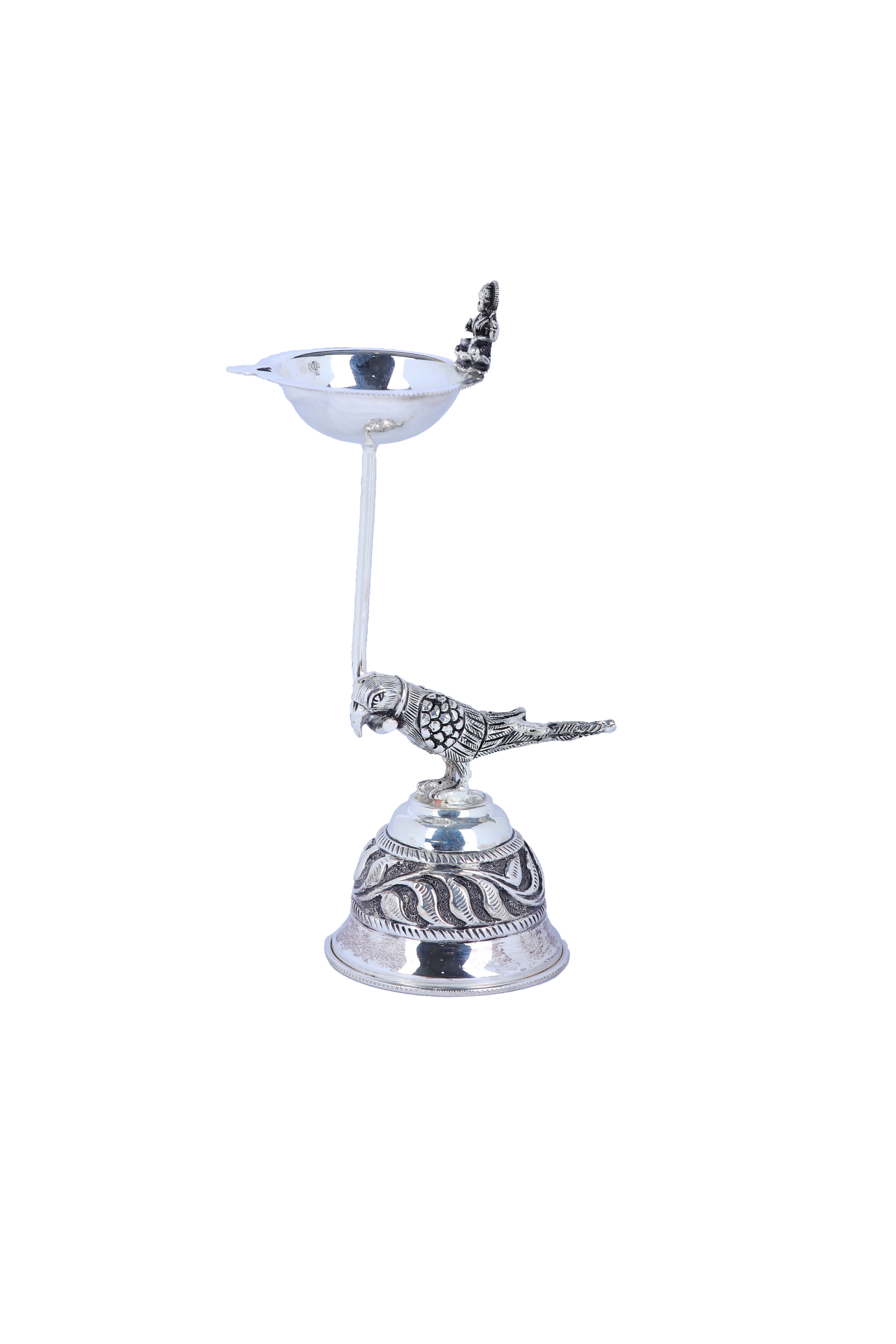 Silver-tone pooja diya lamp with pedestal, engraved base, and bird & deity figurines