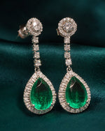 Shop designer silver earrings for women with green teardrop stones and an elegant long-drop design.