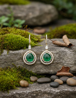 Designer silver earrings for women featuring round green stones and intricate floral enamel detailing.