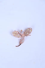 Designer silver brooch featuring a crystal-studded bird motif worn on a sherwani pocket.