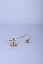 Silver-plated aarti diya oil lamp with two cup holders, angled view