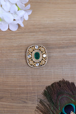 Ornate green gemstone rhinestone brooch for men.