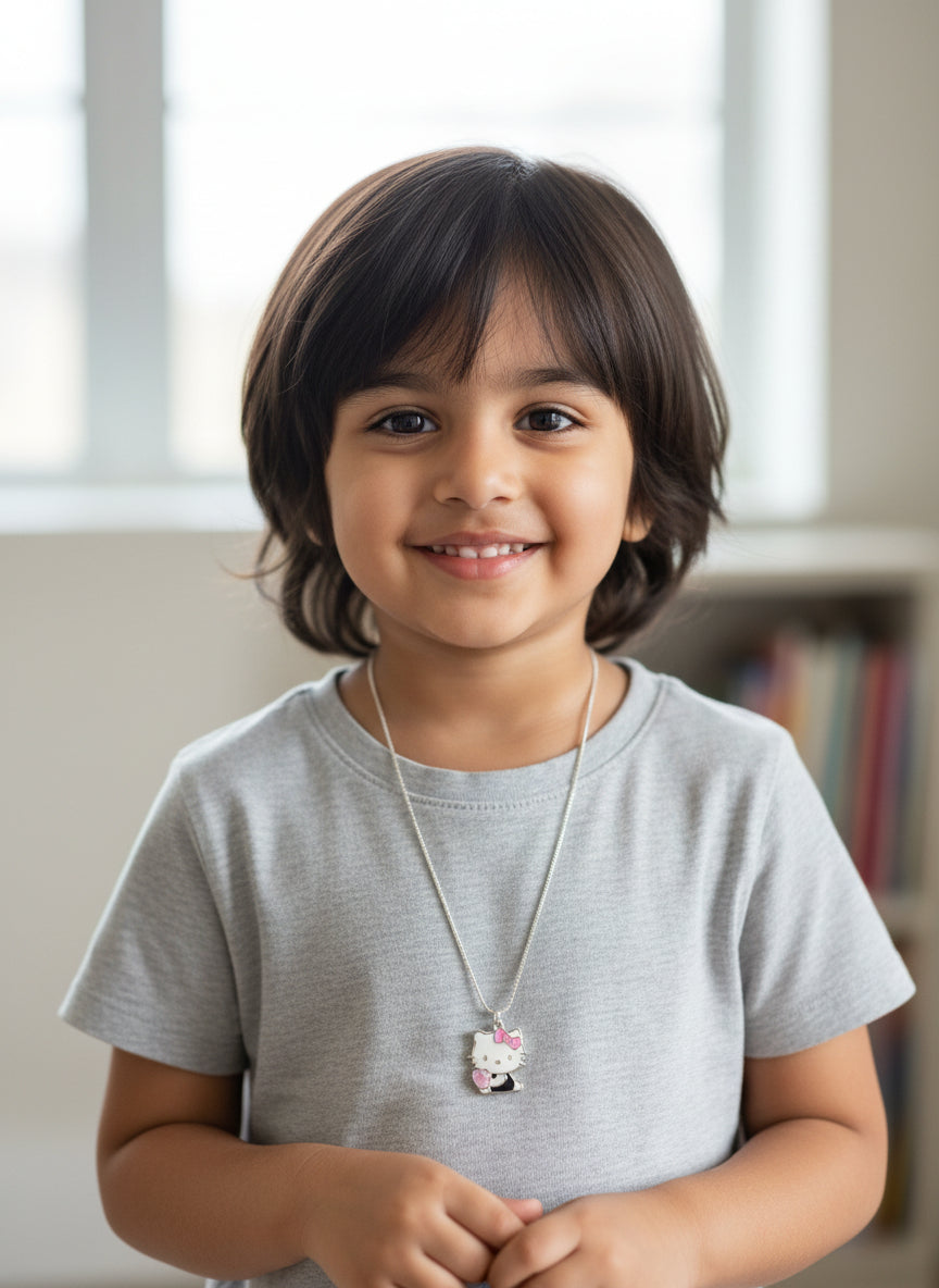 Kids silver charm necklace worn by a child, featuring a cat pendant on a chain