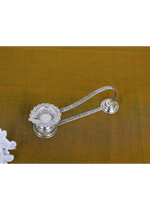 Silver lotus-petal aarti diya with long handle and wick cup, ornate base