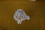 Multi-tier silver aarti lamp with perforated tiers and central diya holder, close view