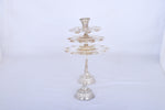 Silver multi-tier aarti lamp on round base with central stem and top cup