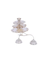 Silver candle holder with three small bells on a white background