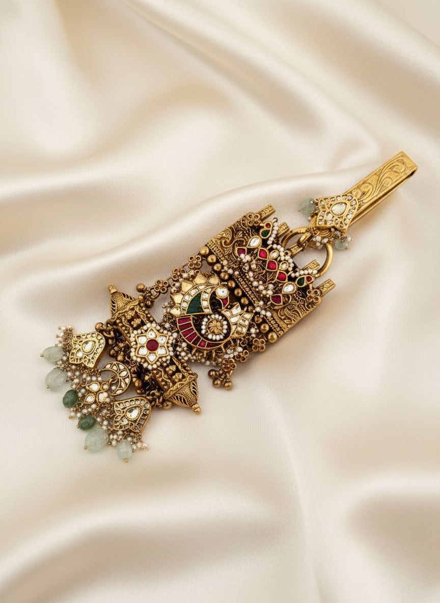 Ornate silver keychain with gold-tone filigree and red, green, white gemstone accents