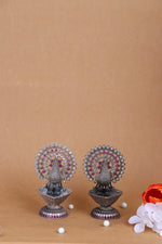 Pair of silver peacock oil diyas, jeweled peacock fan design with purple accents