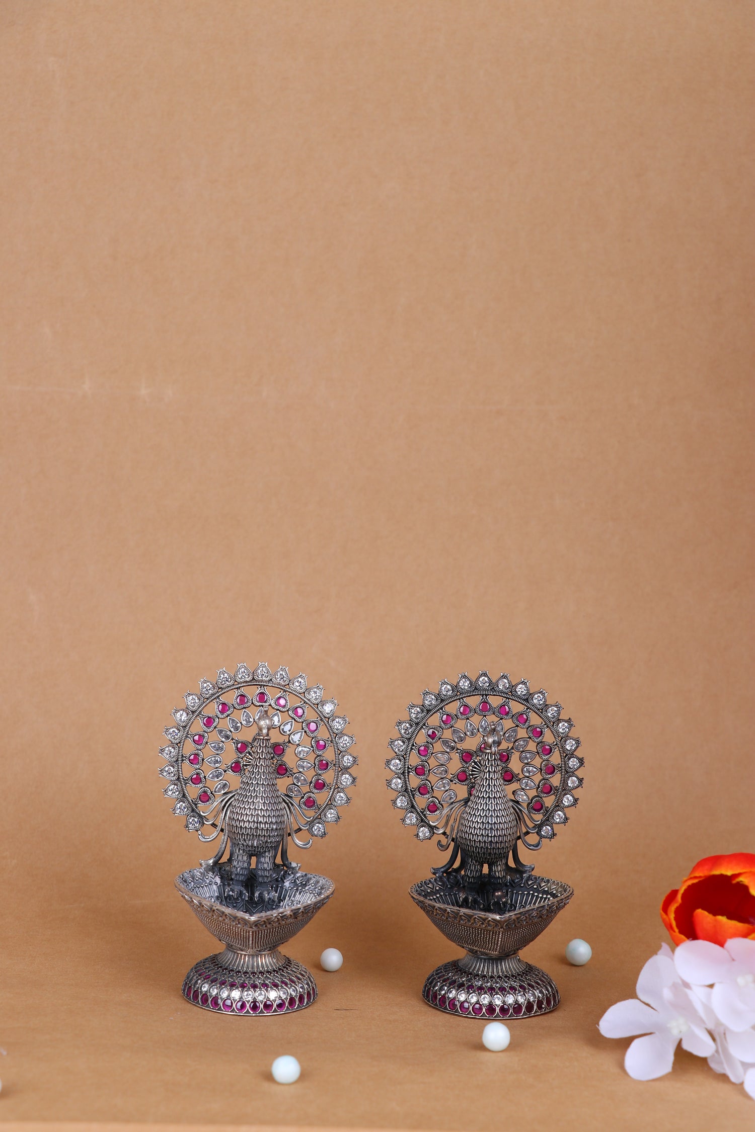 Pair of silver peacock oil diyas, jeweled peacock fan design with purple accents