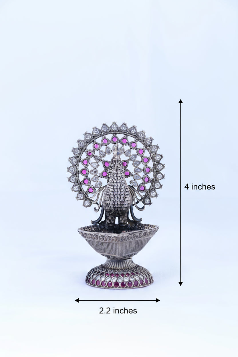 Silver-tone peacock oil diya, 2.2 in wide and 4 in tall, purple gemstone fan
