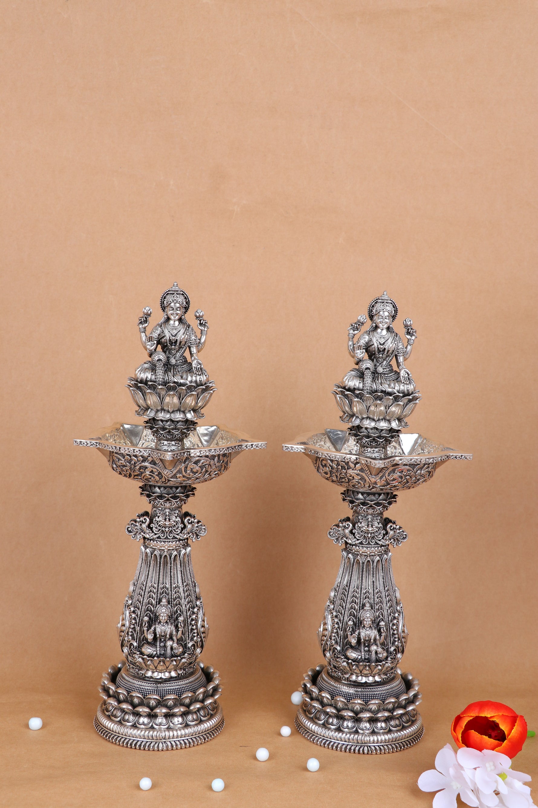 Set of 2 ornate silver mandir diya stands with deity figures and flared lamp trays
