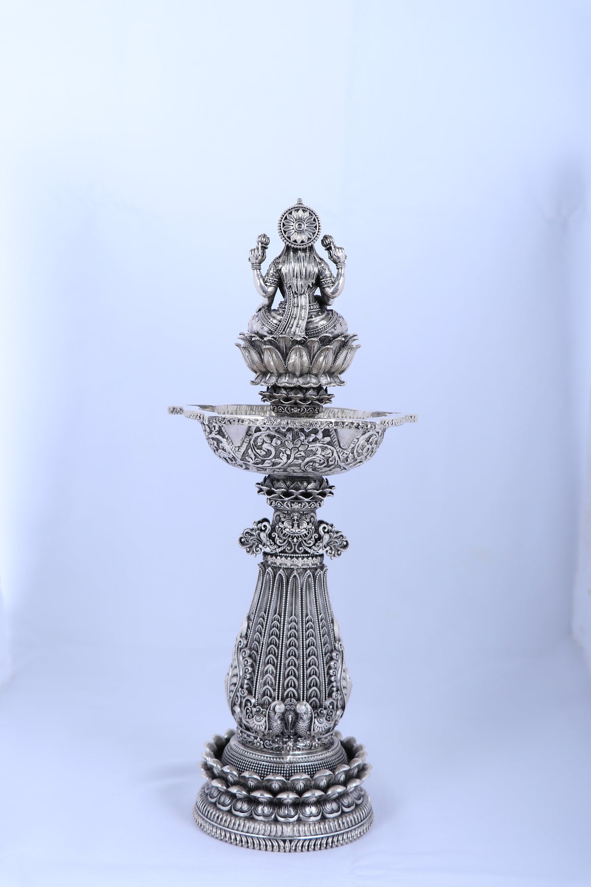 Silver mandir diya stand with pedestal base and raised lamp bowl for temple use