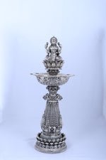 Silver mandir diya stand with pedestal base and raised lamp bowl for temple use