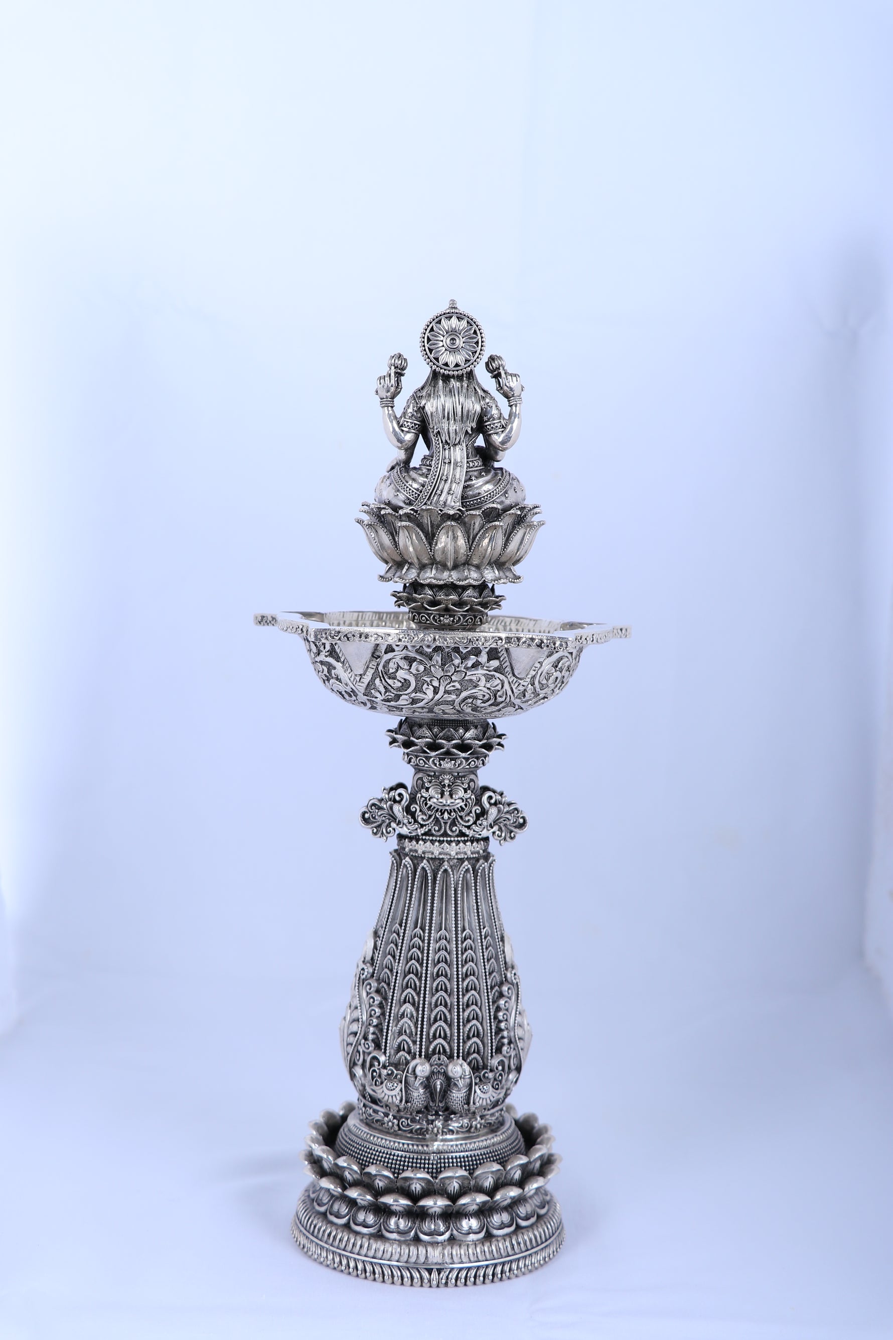 Silver mandir diya stand with pedestal base and raised lamp bowl for temple use