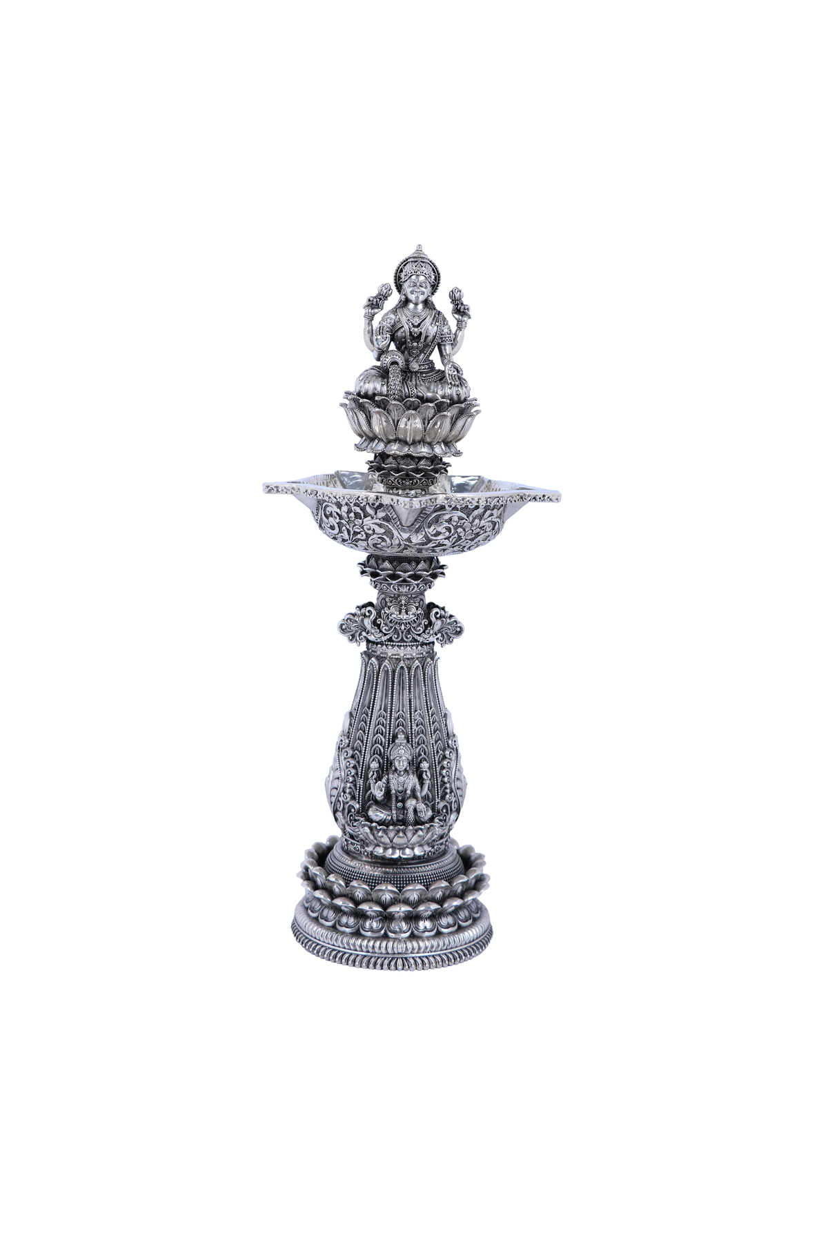 Ornate silver mandir diya stand with multi-tier base and central deity figure