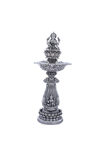 Ornate silver mandir diya stand with multi-tier base and central deity figure