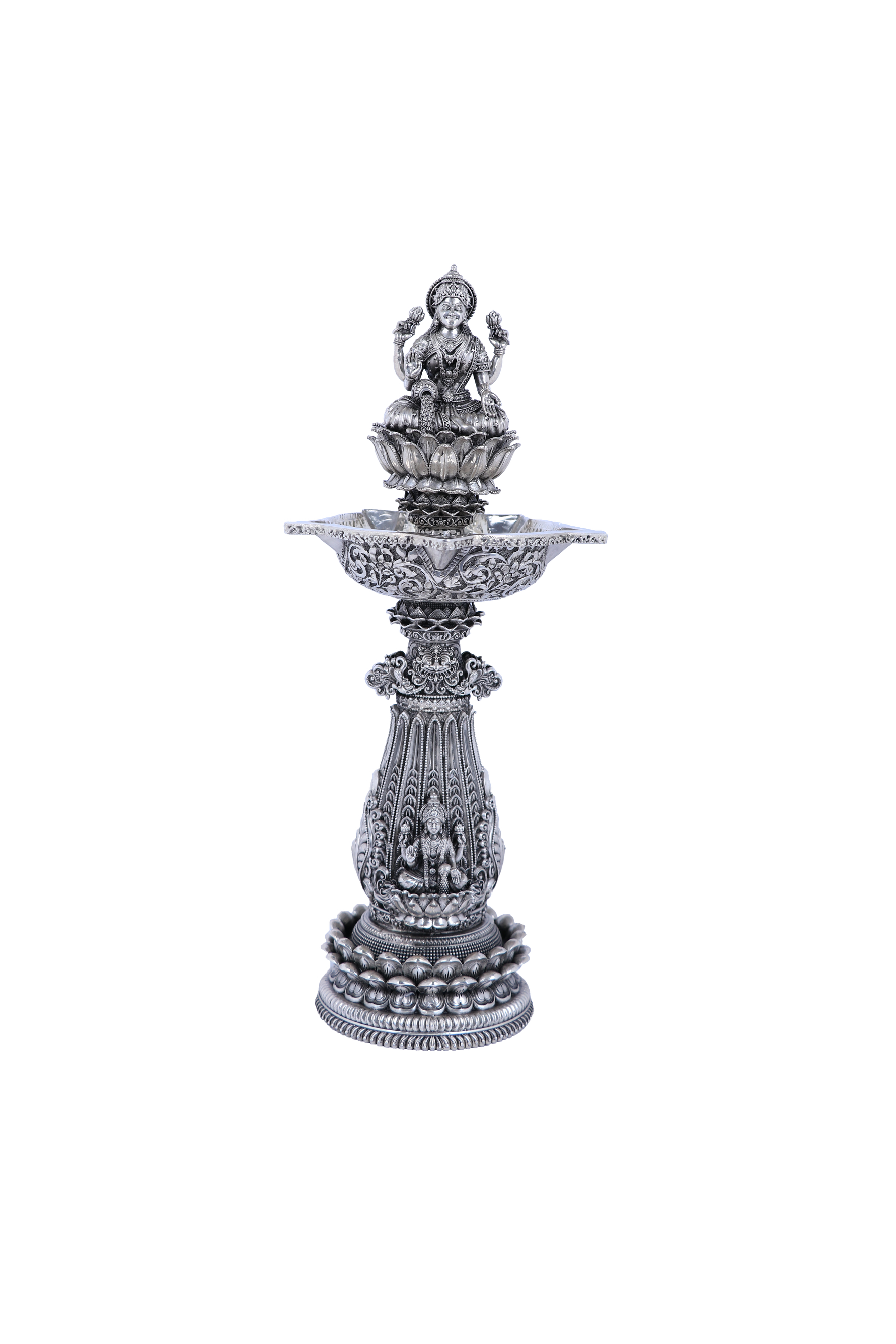 Ornate silver mandir diya stand with multi-tier base and central deity figure