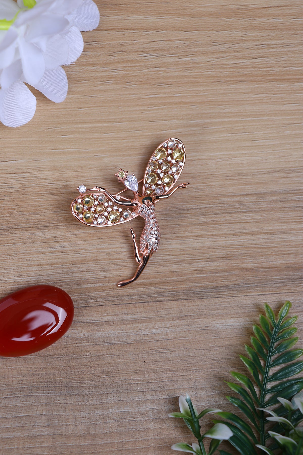 Pure silver bird brooch with clear crystals pinned on a navy blue sherwani lapel.