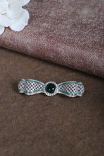 Sterling silver brooch with green center stone and crystal accents
