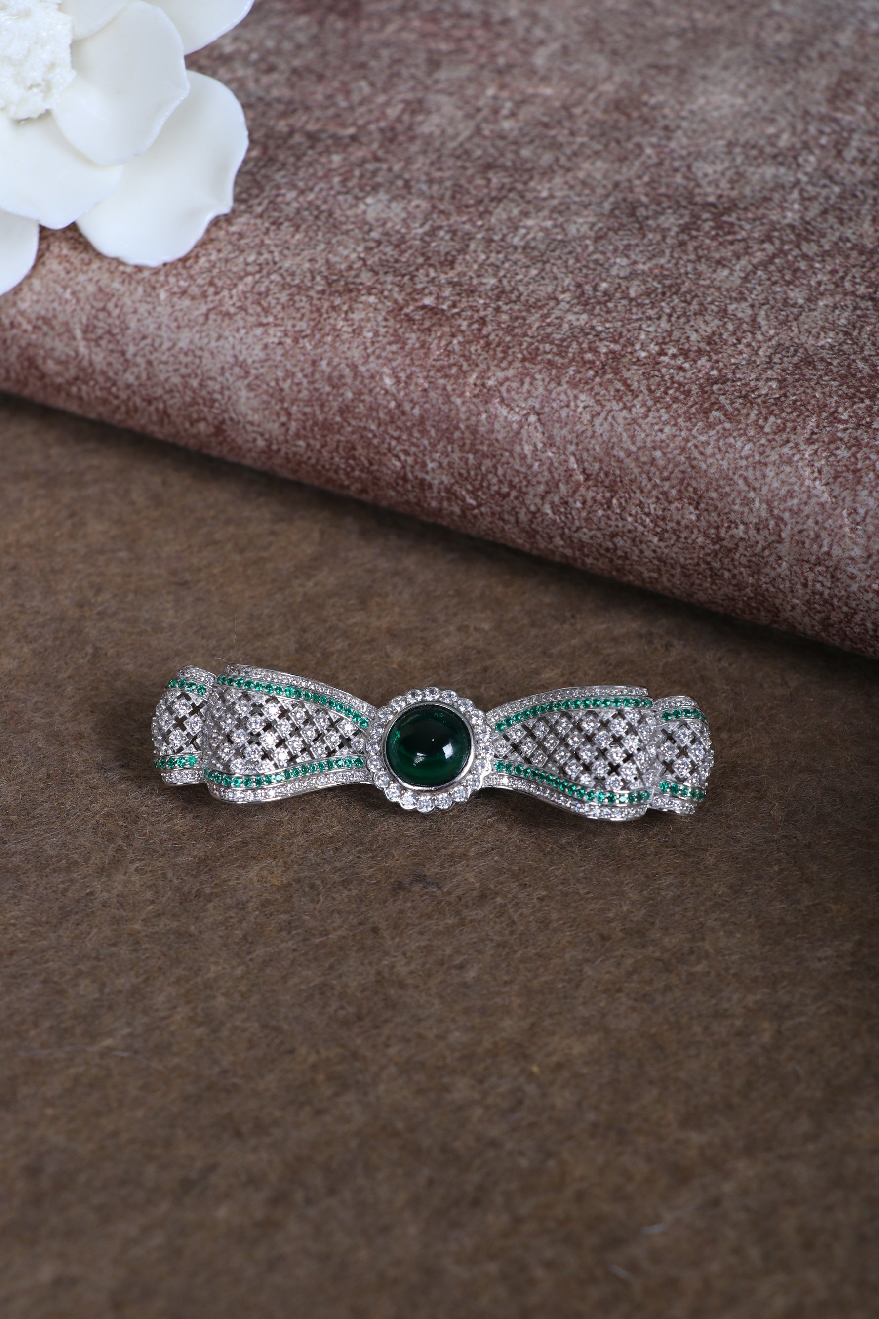 Sterling silver brooch with green center stone and crystal accents