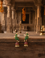 Traditional green and red jhumka-style dangling earrings with gold beads