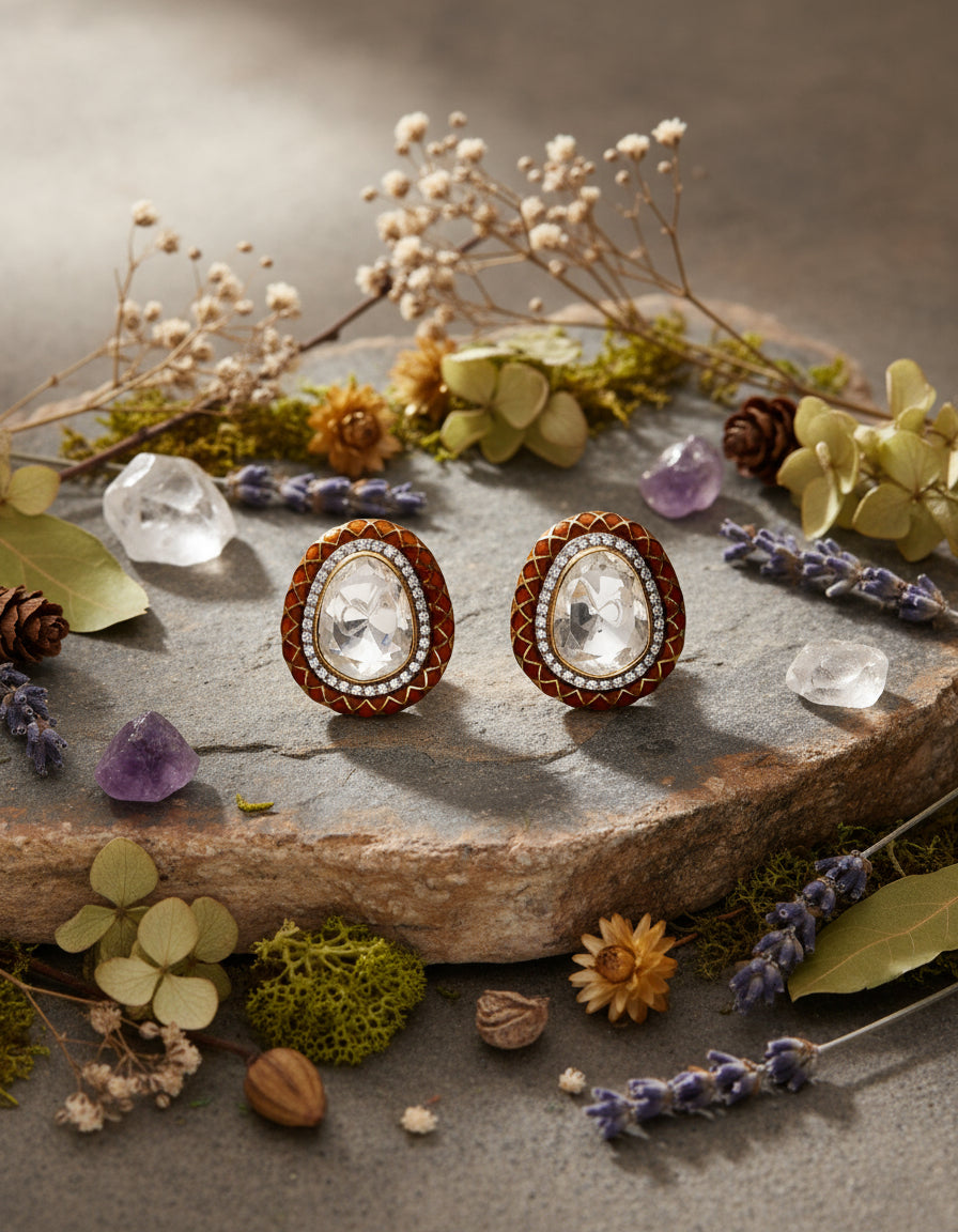 Pure silver oval stud earrings for women with a faceted white centre stone and sparkling crystal border.