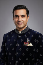 Pure silver peacock brooch with colourful crystals worn on a navy blue sherwani.