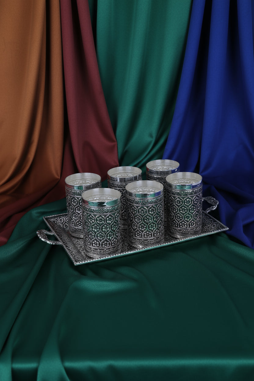Silver fluted tumbler set on rectangular tray with geometric engravings