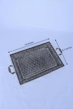 Rectangular silver serving tray with ornate geometric pattern and side handles